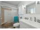 Bright bathroom featuring a glass enclosed shower and a white vanity with ample storage at 11011 N Coggins Dr, Sun City, AZ 85351