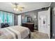 Comfortable bedroom with ensuite bathroom, a ceiling fan, and decorative wall art at 11011 N Coggins Dr, Sun City, AZ 85351