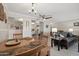 Cozy dining room with wood table set, open to the kitchen and living area at 11011 N Coggins Dr, Sun City, AZ 85351