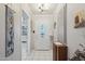 Bright entryway with tiled flooring, adjacent views of the kitchen, and an adjacent storage cabinet at 11011 N Coggins Dr, Sun City, AZ 85351