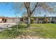 Charming home with a well-manicured lawn, mature shade trees, and a two-car garage at 11011 N Coggins Dr, Sun City, AZ 85351
