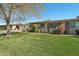 Charming single-story home featuring a well-manicured lawn and mature landscaping at 11011 N Coggins Dr, Sun City, AZ 85351