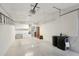 Spacious garage with ample storage space, shelving, and painted concrete floors at 11011 N Coggins Dr, Sun City, AZ 85351