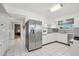 Bright kitchen features stainless steel appliances, white cabinetry, and tile flooring at 11011 N Coggins Dr, Sun City, AZ 85351