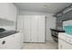 Well-equipped laundry room with modern appliances, abundant cabinets, and tiled flooring at 11011 N Coggins Dr, Sun City, AZ 85351