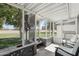 Relaxing screened-in sunroom with tile flooring and views of the lush backyard at 11011 N Coggins Dr, Sun City, AZ 85351