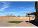 Spacious backyard featuring a patio, artificial turf, and privacy wall at 1132 S 242Nd Ln, Buckeye, AZ 85326