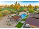 Beautiful aerial view of the backyard pool, covered patio, and landscaped lawn, with a golf course nearby at 11801 N Sundown Dr, Scottsdale, AZ 85260