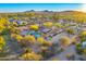 Expansive aerial view of the property featuring a private pool, lush desert landscaping, and mountain views at 11801 N Sundown Dr, Scottsdale, AZ 85260