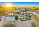 Aerial view of property featuring swimming pool, outdoor kitchen, manicured lawns, and stunning desert landscape at 11801 N Sundown Dr, Scottsdale, AZ 85260