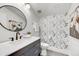 Stylish powder room with a dark vanity, floral wallpaper, and modern fixtures at 11801 N Sundown Dr, Scottsdale, AZ 85260