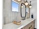 Stylish bathroom vanity with marble countertop, modern fixtures, decorative mirror, and ample natural light at 11801 N Sundown Dr, Scottsdale, AZ 85260