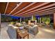 Inviting outdoor living space with covered patio, fireplace, and comfortable seating for relaxing and entertaining at 11801 N Sundown Dr, Scottsdale, AZ 85260
