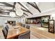 Open-concept dining area featuring statement lighting, wood floors, and backyard views at 11801 N Sundown Dr, Scottsdale, AZ 85260