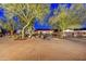 Charming home with desert landscaping, mature trees, stone accents, and inviting walkway to the front entrance at 11801 N Sundown Dr, Scottsdale, AZ 85260
