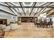 Open living room featuring natural wood floors, beamed ceilings, and sliding glass doors to the patio at 11801 N Sundown Dr, Scottsdale, AZ 85260