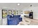 Bright living room with vaulted ceilings, a blue sofa, and a modern entertainment center at 11801 N Sundown Dr, Scottsdale, AZ 85260