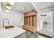 Well-organized mudroom featuring built-in storage, bright lighting, and a convenient sink area at 11801 N Sundown Dr, Scottsdale, AZ 85260
