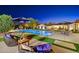 Backyard pool and patio area with comfortable seating and manicured landscaping at dusk at 11801 N Sundown Dr, Scottsdale, AZ 85260