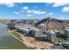 Scenic aerial view of stylish condos near a tranquil river and desert landscape under a bright blue sky at 120 E Rio Salado Pkwy # 101, Tempe, AZ 85281