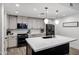 Modern kitchen featuring a white marble island, gray cabinets, stainless steel appliances, and modern lighting at 120 E Rio Salado Pkwy # 101, Tempe, AZ 85281