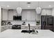 Modern kitchen with a white marble island, gray cabinets, stainless steel appliances, and modern pendant lights at 120 E Rio Salado Pkwy # 101, Tempe, AZ 85281