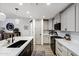 Modern kitchen features sleek black sink, white countertops, and stainless steel appliances at 120 E Rio Salado Pkwy # 101, Tempe, AZ 85281