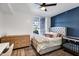 Cozy bedroom with a large window, blue accent wall, and hardwood flooring at 120 E Rio Salado Pkwy # 101, Tempe, AZ 85281