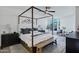 Bedroom features a four-poster bed, large windows, and modern decor at 120 E Rio Salado Pkwy # 101, Tempe, AZ 85281