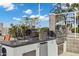 Outdoor kitchen area featuring a grill, pizza oven, sink, mini fridge, and granite countertops at 120 E Rio Salado Pkwy # 101, Tempe, AZ 85281