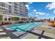 Resort style pool with seating, trees, and building in background on a sunny day at 120 E Rio Salado Pkwy # 101, Tempe, AZ 85281