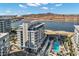 Modern condo building featuring a pool with comfortable lounge chairs and lush landscaping at 120 E Rio Salado Pkwy # 101, Tempe, AZ 85281