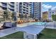 Resort style pool, lounge chairs, umbrellas, table tennis and building in background on a sunny day at 120 E Rio Salado Pkwy # 101, Tempe, AZ 85281