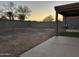 Spacious backyard with a covered patio and block wall fence at 12733 W Boca Raton Rd, El Mirage, AZ 85335