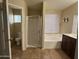 Spacious bathroom featuring a separate shower, soaking tub, and vanity with dual sinks at 12733 W Boca Raton Rd, El Mirage, AZ 85335