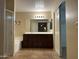 Well-lit bathroom boasts a large vanity with ample storage, a soaking tub, and tiled flooring at 12733 W Boca Raton Rd, El Mirage, AZ 85335