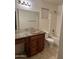 Bathroom features a granite vanity, neutral walls, and a combined shower and tub at 12733 W Boca Raton Rd, El Mirage, AZ 85335