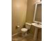 Cozy bathroom with a pedestal sink, toilet, and a framed mirror at 12733 W Boca Raton Rd, El Mirage, AZ 85335