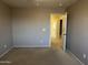 Neutral bedroom with a door leading to other rooms at 12733 W Boca Raton Rd, El Mirage, AZ 85335