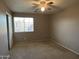Bedroom with window, plush carpeting, and closet at 12733 W Boca Raton Rd, El Mirage, AZ 85335