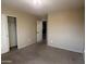 Neutral bedroom with plush carpet, a ceiling fan, and a closet for storage at 12733 W Boca Raton Rd, El Mirage, AZ 85335