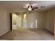 Large bedroom with a ceiling fan, neutral carpet, and a walk-in closet at 12733 W Boca Raton Rd, El Mirage, AZ 85335