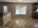 Bright dining room with tile floors, large window and a kitchen bar counter at 12733 W Boca Raton Rd, El Mirage, AZ 85335