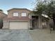 Traditional two-story home with a two-car garage, tile roof and well-kept front yard at 12733 W Boca Raton Rd, El Mirage, AZ 85335