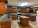 Well-equipped kitchen with granite counters, stainless appliances and dark wood cabinets at 12733 W Boca Raton Rd, El Mirage, AZ 85335