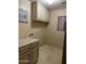 Functional laundry room with counter space, storage cabinets, and a convenient sink at 12733 W Boca Raton Rd, El Mirage, AZ 85335