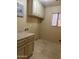 Laundry room with beige cabinets, light countertops and tile flooring at 12733 W Boca Raton Rd, El Mirage, AZ 85335