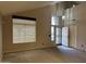 Living room featuring carpet, window and entry door at 12733 W Boca Raton Rd, El Mirage, AZ 85335