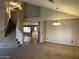 Open floor plan with carpeted living room and tile flooring leading to the kitchen at 12733 W Boca Raton Rd, El Mirage, AZ 85335