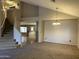Open floor plan with carpeted living room and tile flooring leading to the kitchen at 12733 W Boca Raton Rd, El Mirage, AZ 85335